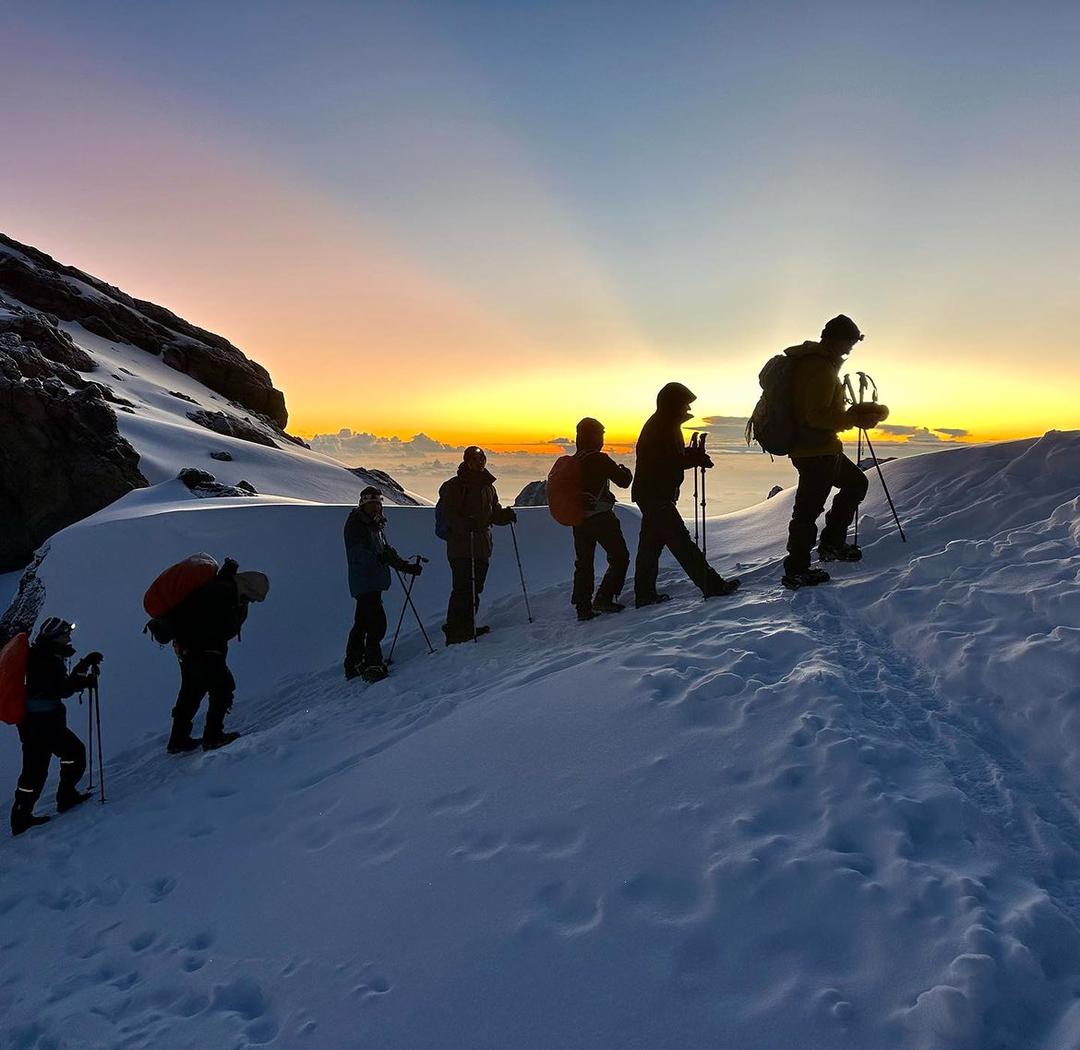 Kilimanjaro sunrise with climber silhouettes