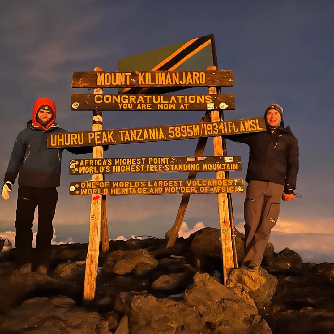 Couple at Uhuru Peak summit sign